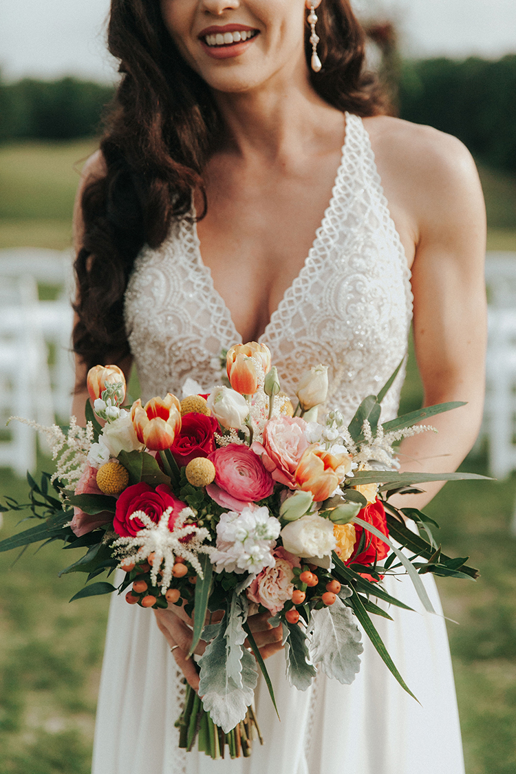 Colorful Wedding Bouquet with Tulips, Ranunculus, and Roses | photo by Deltalow | featured on I Do Y'all 