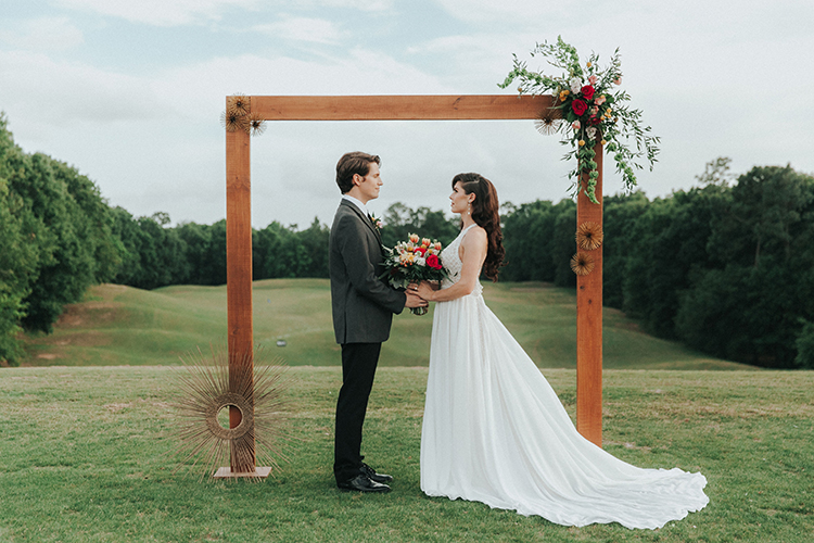 Wooden Wedding Arch with Gold Sunbursts | photo by Deltalow | featured on I Do Y'all