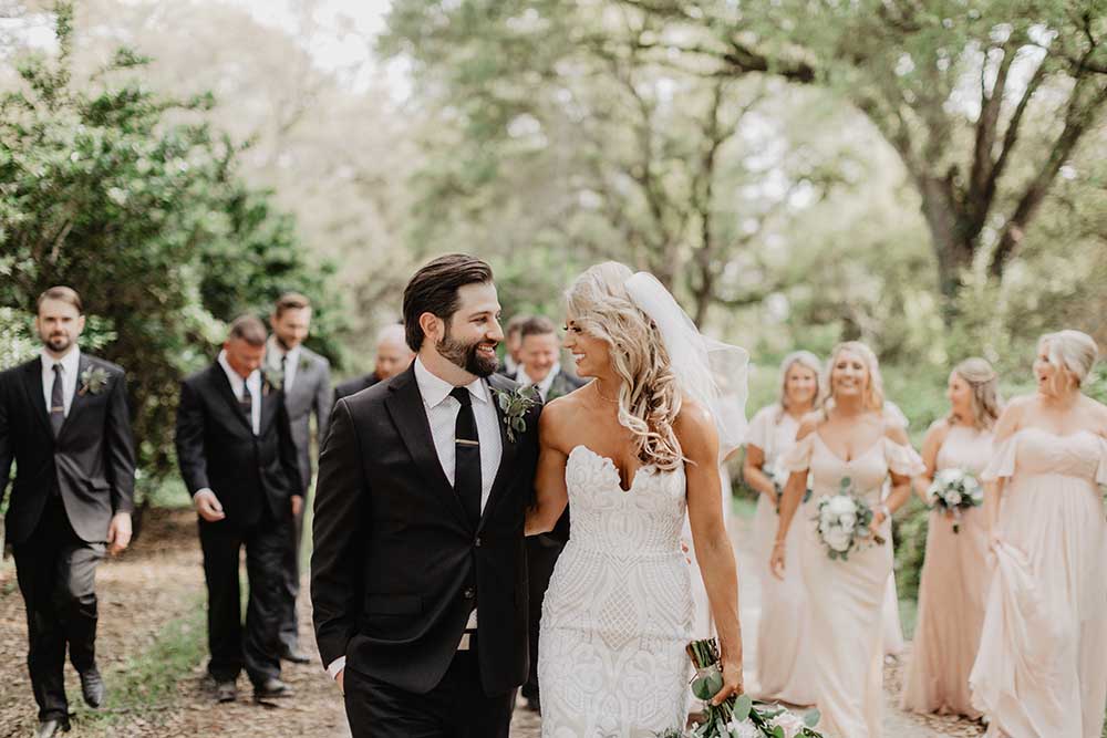 Wedding Portraits with Wedding Party Behind | photo by Emily Green Photography | featured on I Do Y'all