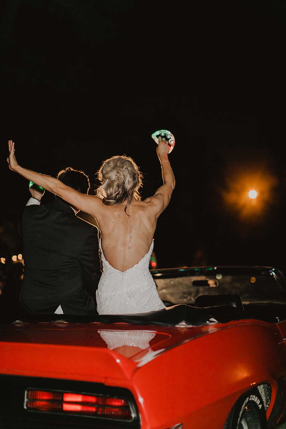 Bride & Groom Leaving in Red Convertible | photo by Emily Green Photography | featured on I Do Y'all