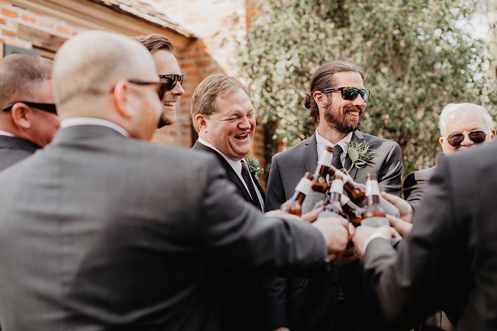 Groomsmen Cheersing Beers at Fun Louisiana Wedding | photo by Emily Green Photography | featured on I Do Y'all