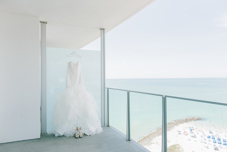 Wedding Dress Hanging on Balcony Overlooking the Ocean | photo by Kera Photography | featured on I Do Y'all for 10 Smart Tips for Long-Distance Wedding Planning