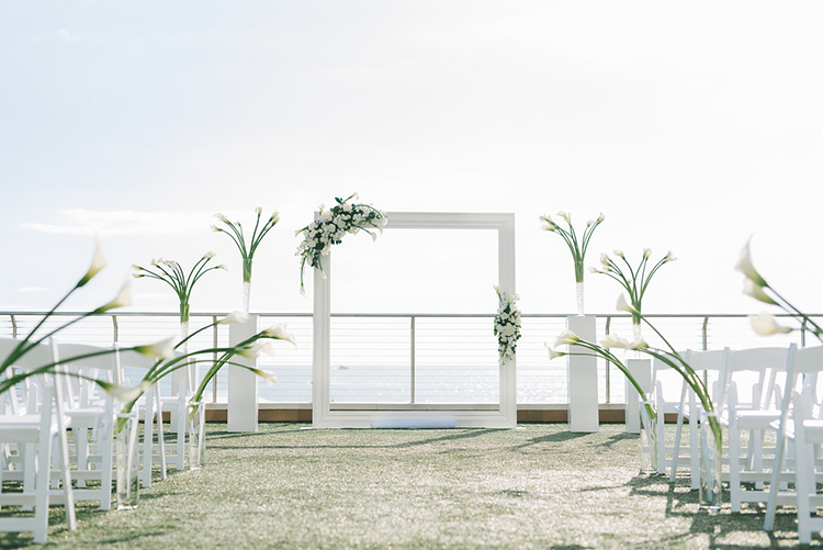 Modern Oceanside All-White Wedding Ceremony Decor | photo by Kera Photography | featured on I Do Y'all