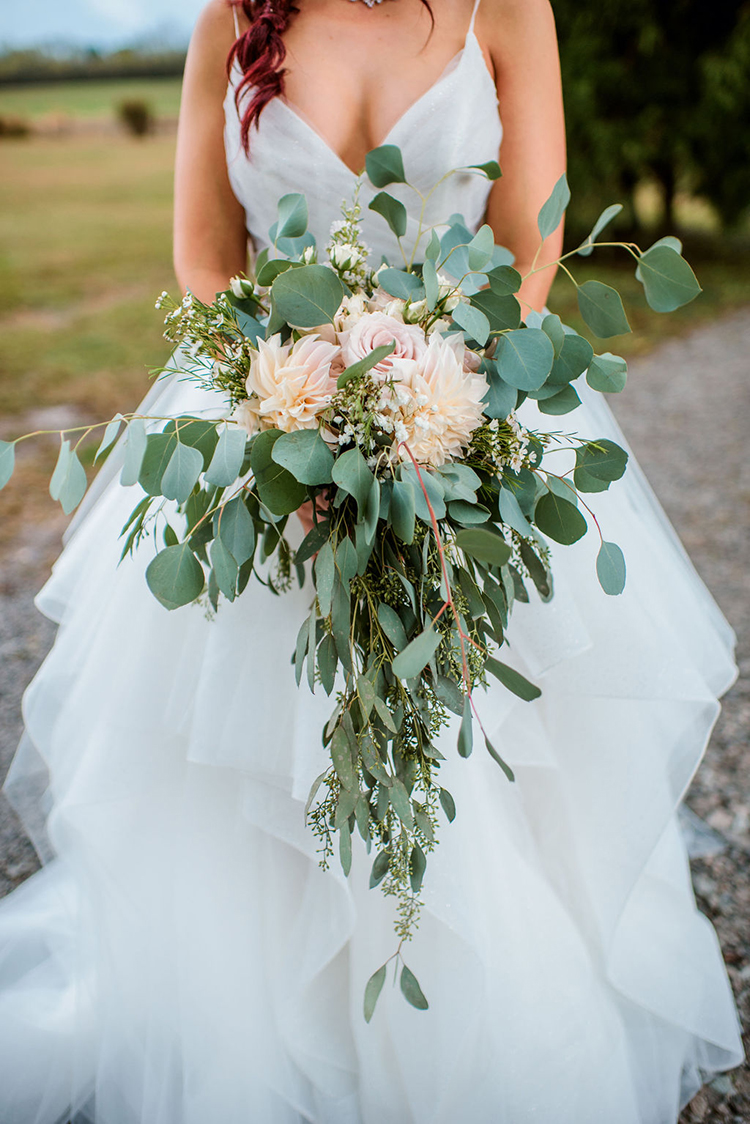 Lush wedding bouquet with dahlias, roses, and eucalyptus leaves | photo by John Myers Photography | featured on I Do Y'all