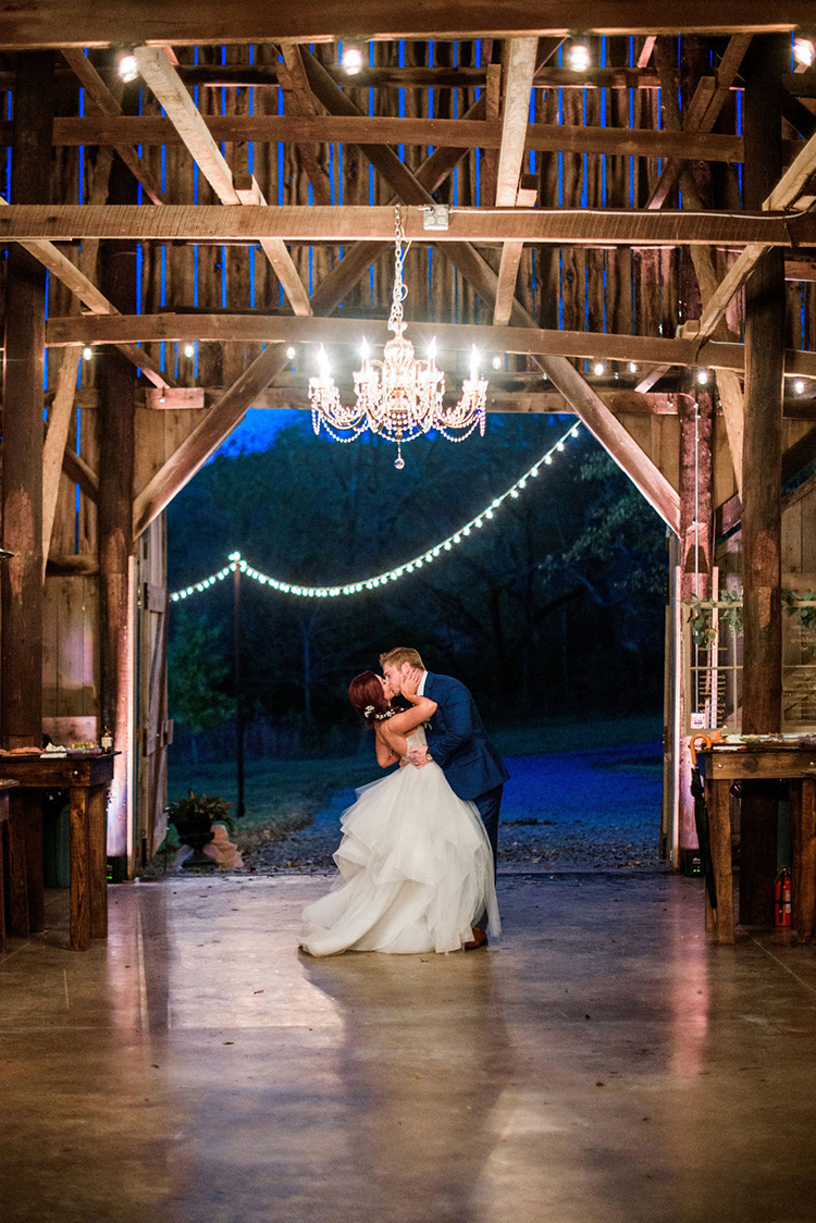 Bride & Groom Kiss during First Dance at Joyful & Bright Barn Wedding | photo by John Myers Photography | featured on I Do Y'all