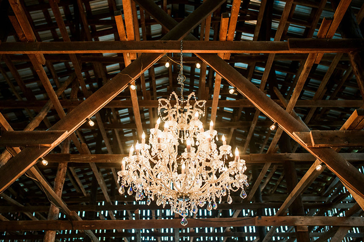 Chandelier in wedding barn | photo by John Myers Photography | featured on I Do Y'all