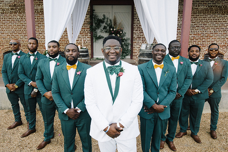 Groom in White Suit & Groomsmen in Emerald Suits with Bowties | photo by Staci Lewis Photography | featured on I Do Y'all