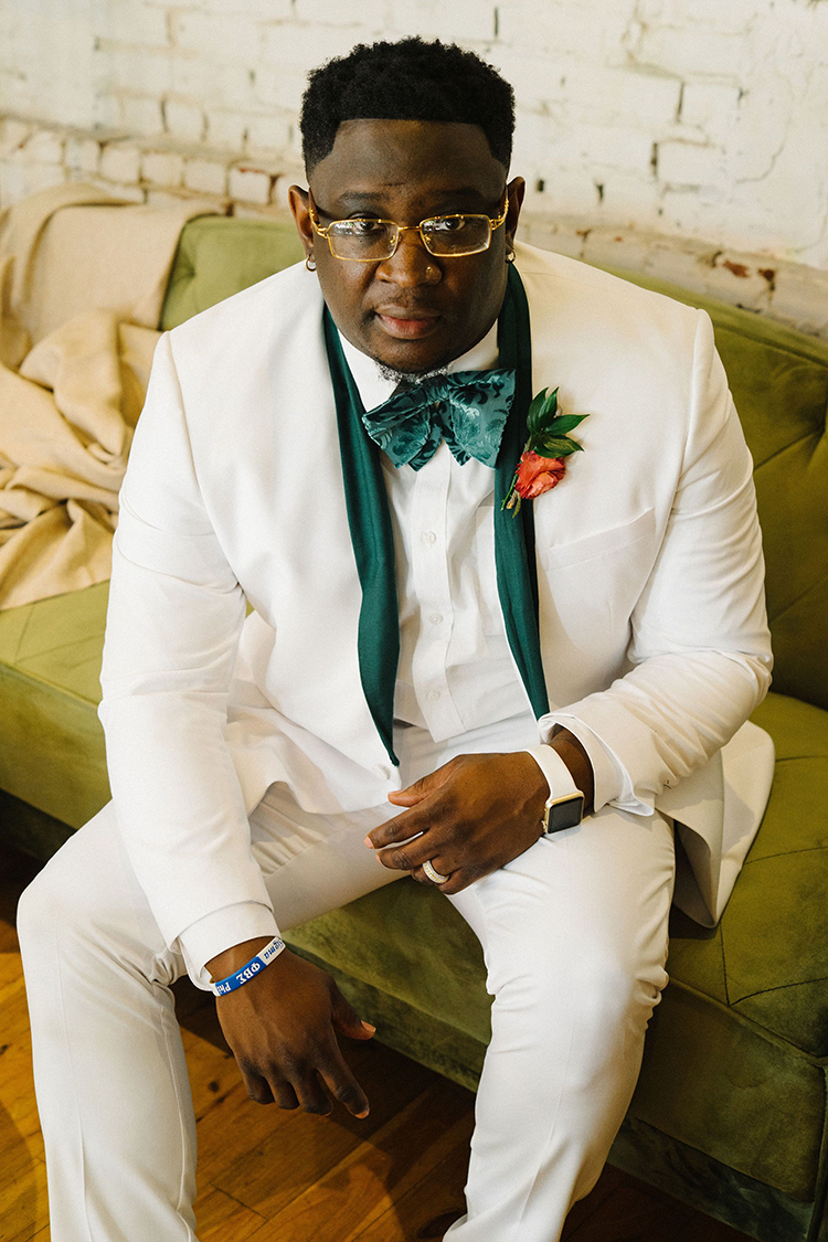 Groom in All White Wedding Suit with Emerald Lapels & Bowtie | photo by Staci Lewis Photography | featured on I Do Y'all