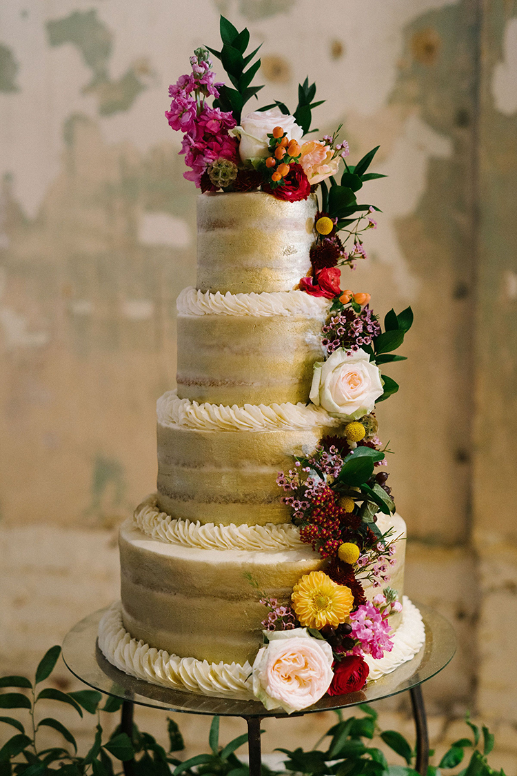 4-Tiered Gold Painted Wedding Cake with Lush Floral Pieces | photo by Staci Lewis Photography | featured on I Do Y'all