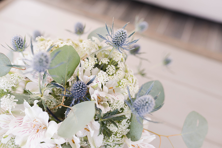 Beachy wedding bouquet with sea holly thistles and orchids | photo by Southern Wedding Pixels | featured on I Do Y'all