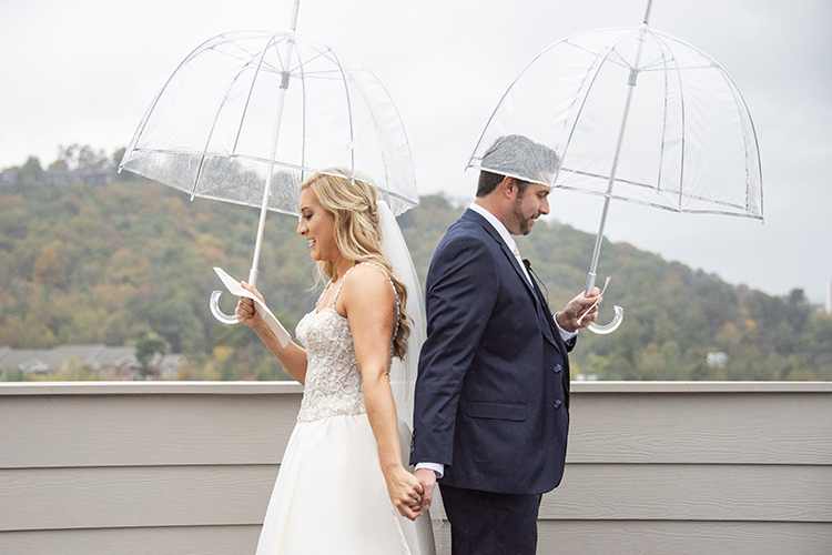 Bride & Groom Reading Letters to Each Other Under Umbrellas | photo by Jessica Merithew Photography | featured on I Do Y'all