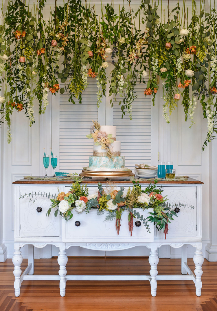 Wedding Cake Display with Hanging Florals & Greenery | Vintage Shabby Chic Wedding Cake Display | photo by Radiant Photography by Sydney Danielle