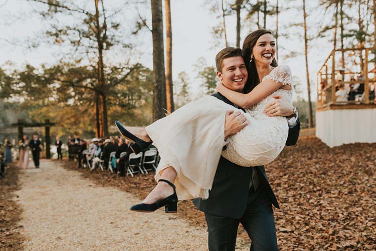 Groom Carrying Bride Down Aisle for Fall Wedding | photo by Jen Menard Photography | featured on I Do Y'all