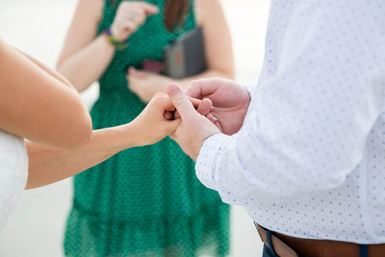 Exchanging Rings at Sunrise Beach Elopement | photo by Dreamscape Photography, LLC