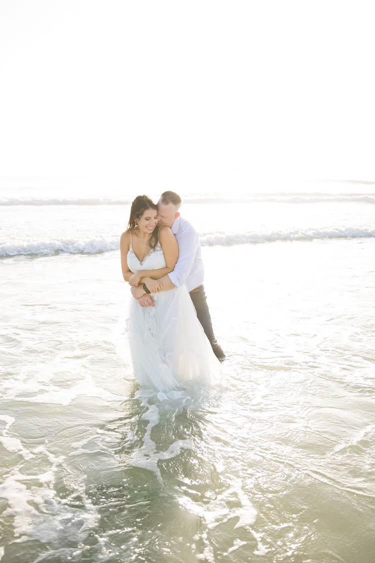 Bride & Groom in Ocean at Sunrise Beach Elopement | photo by  Dreamscape Photography, LLC