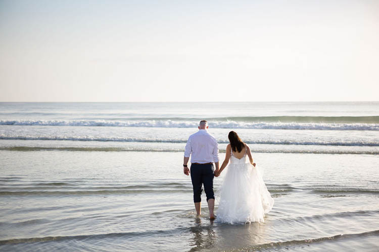 Bride & Groom in Ocean at Sunrise Beach Elopement | photo by  Dreamscape Photography, LLC