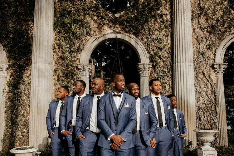 Groom & Groomsmen in Blue Suits with Black Ties & Bowties | photo by The Portos