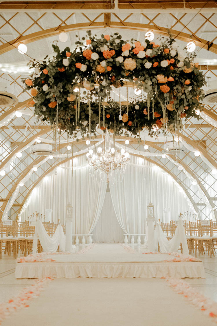 Glamorous & Chic White & Gold Wedding Ceremony with Hanging Floral Centerpiece | photo by The Portos