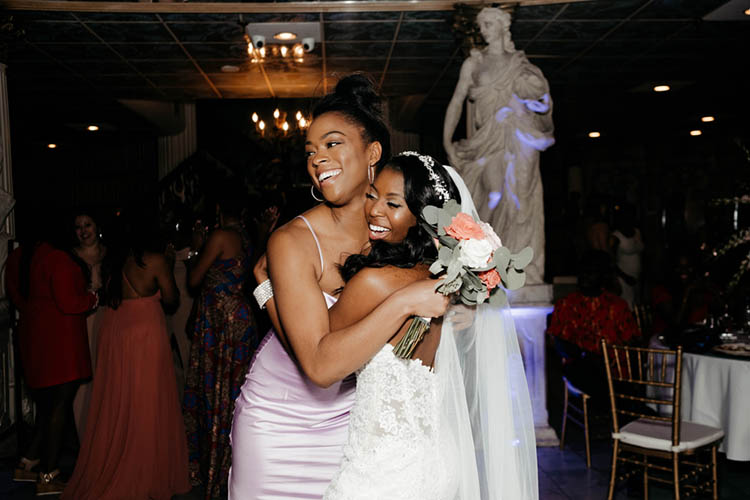 Bride Hugging Guest Who Caught Bouquet at Glamorous Wedding | photo by The Portos