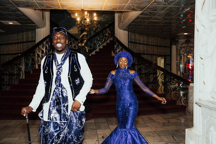 Couple in Nigerian Wedding Attire Re-Entering Wedding  photo by The Portos