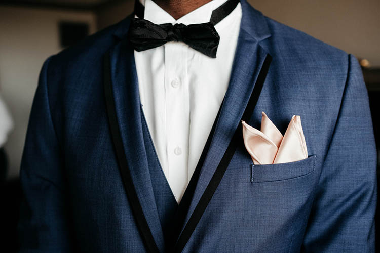 Groom in Blue Suit with Outlined Black Lapels and Black Bowtie | photo by The Portos