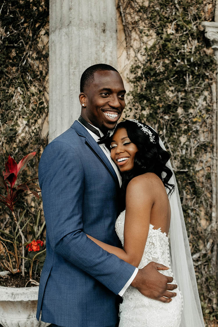 Glamorous Wedding Couple Hugging & Smiling | photo by The Portos