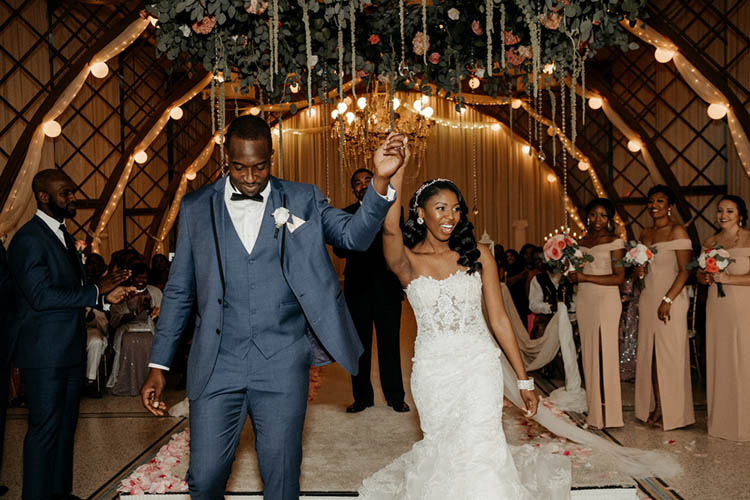 Bride & Groom Celebrate Walking down the Aisle | photo by The Portos