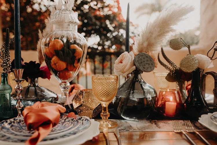 Bohemian Wedding Table Decor with Oranges and Antique Colored Glassware | photo by Boote Photography Studio